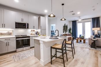 Wood-style flooring in living, dining, and bath areas